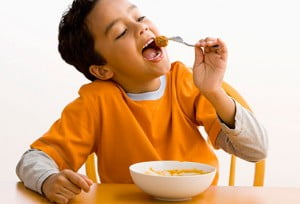 getty rf photo of boy eating meatball